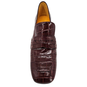 Brown leather loafer with crocodile pattern on a white background