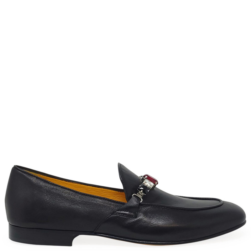 Black loafer shoe with a decorative buckle on a white background