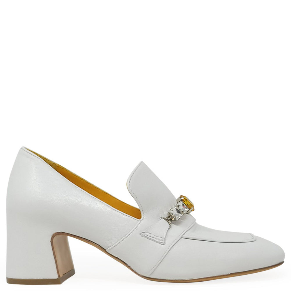 White loafer shoe with a decorative buckle on a white background