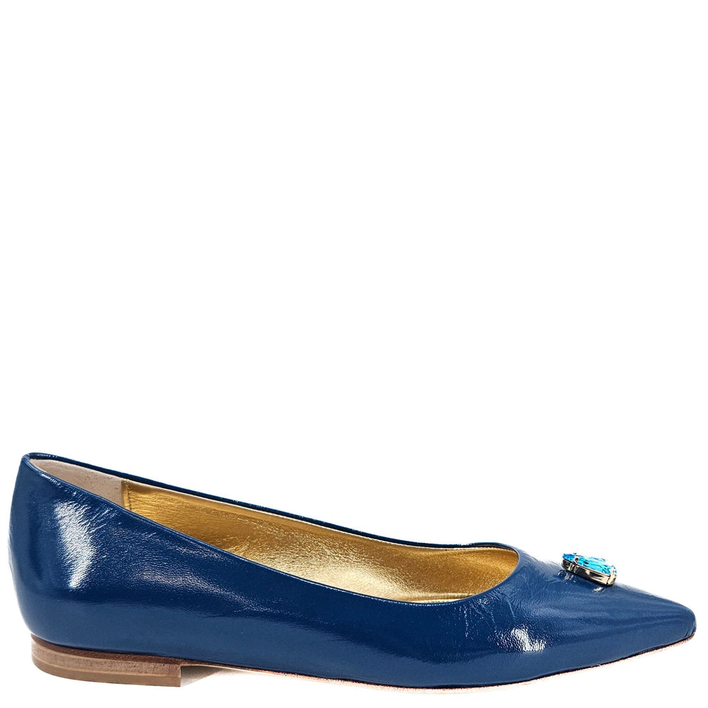 Blue patent leather shoe with a gold interior on a white background