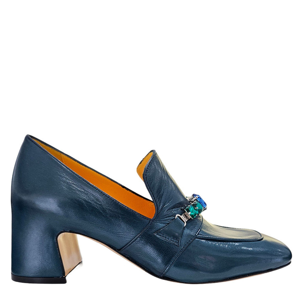 Blue shoe with a decorative brooch on a white background