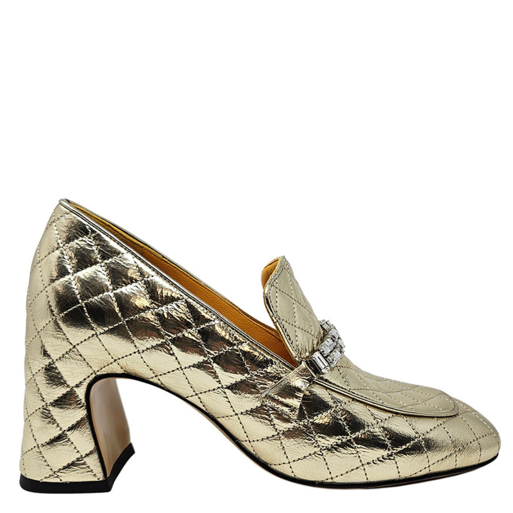Gold quilted shoe with a decorative buckle on a white background