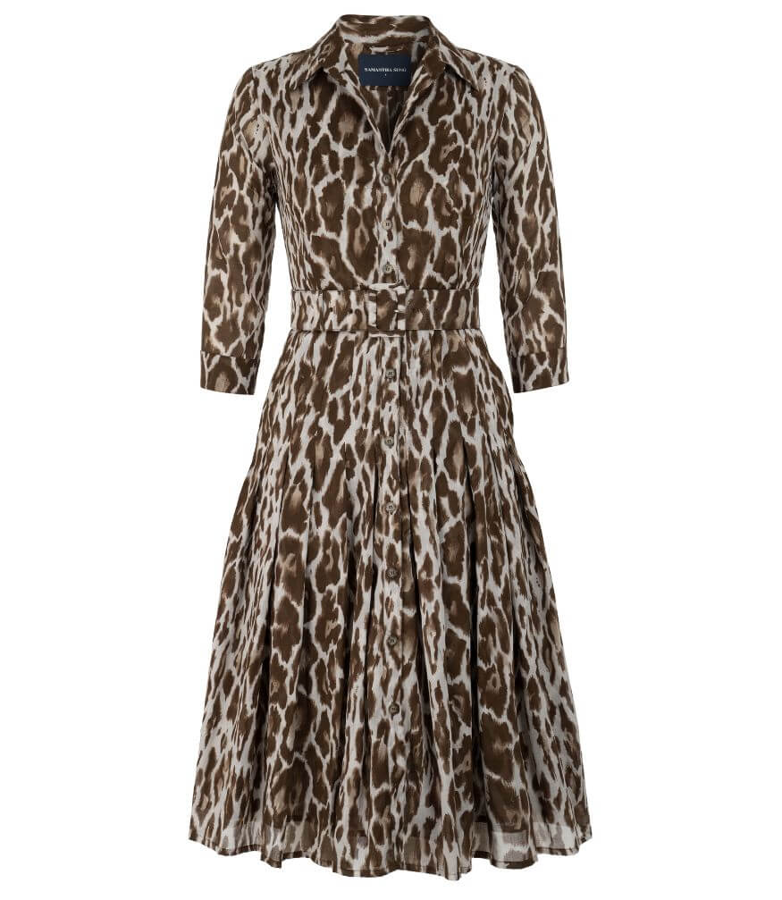 A knee-length dress with a collared neckline, three-quarter sleeves, and a flared skirt. Features a bold allover abstract pattern and fitted waist.