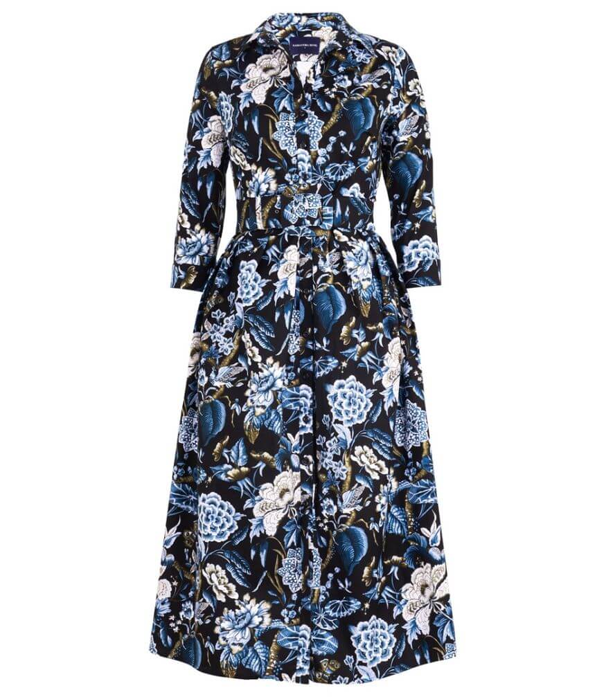 A knee-length dress with a collared neckline, three-quarter sleeves, and a flared skirt. Features a bold allover abstract pattern and fitted waist.