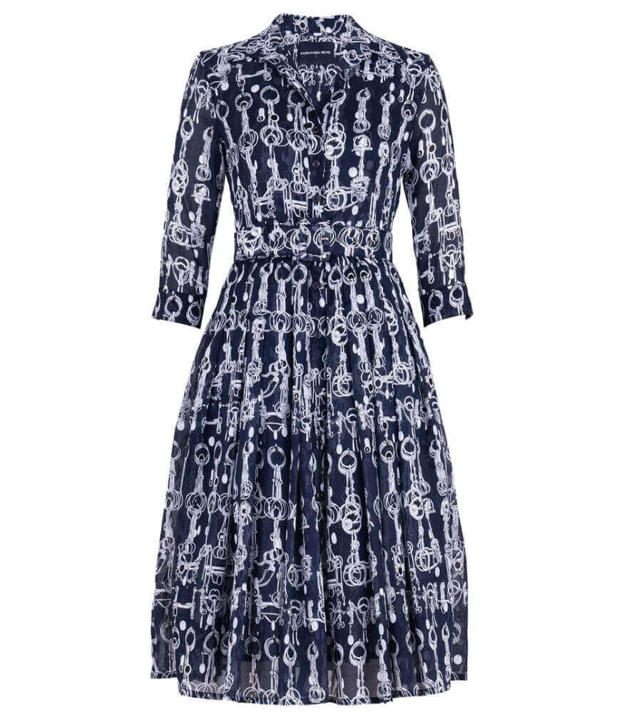 A knee-length dress with a collared neckline, three-quarter sleeves, and a flared skirt. Features a bold allover abstract pattern and fitted waist.