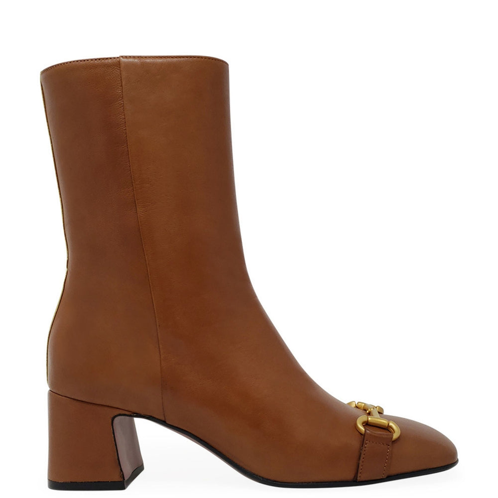 Brown leather boot with gold buckle on a white background