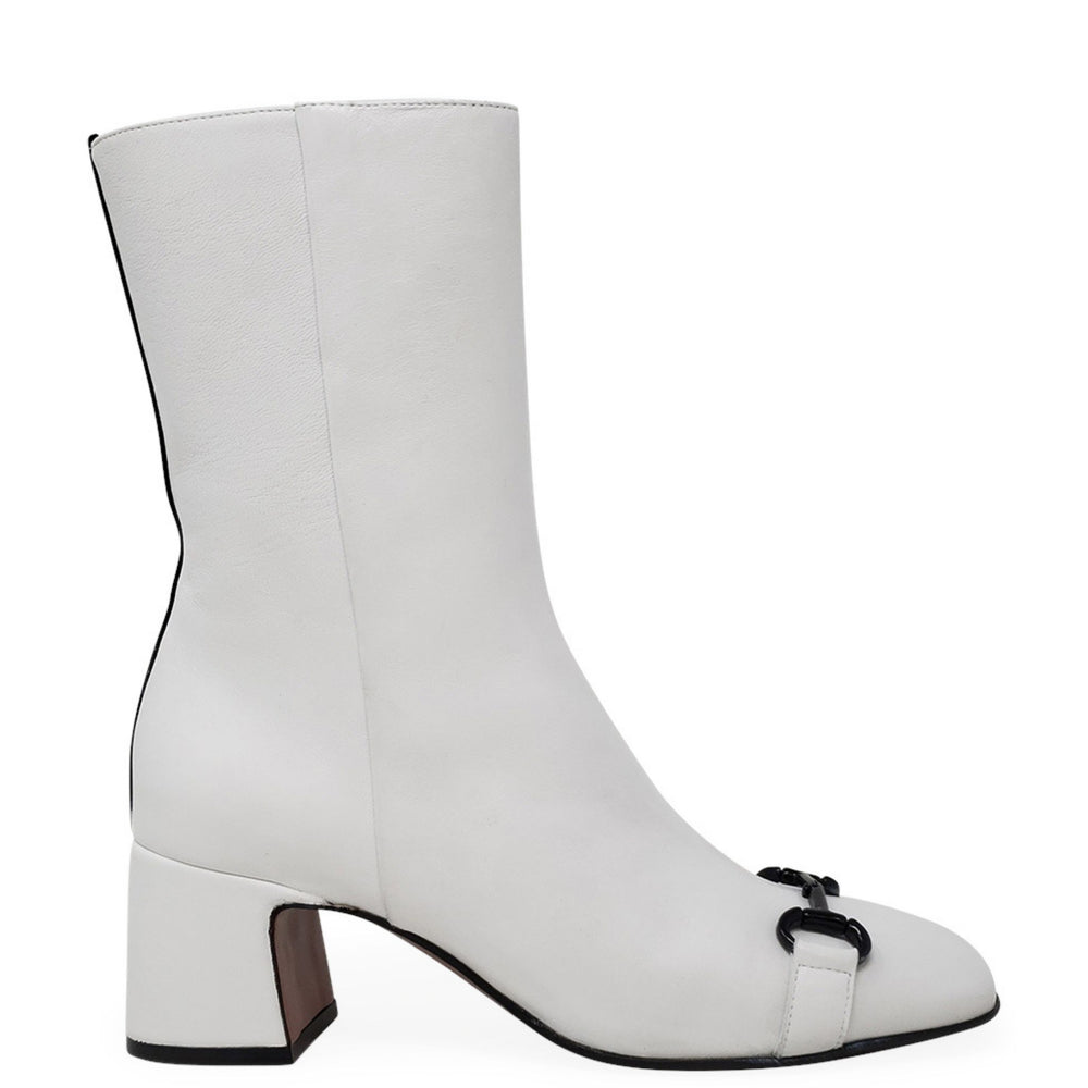 White ankle boot with a small black buckle on a white background