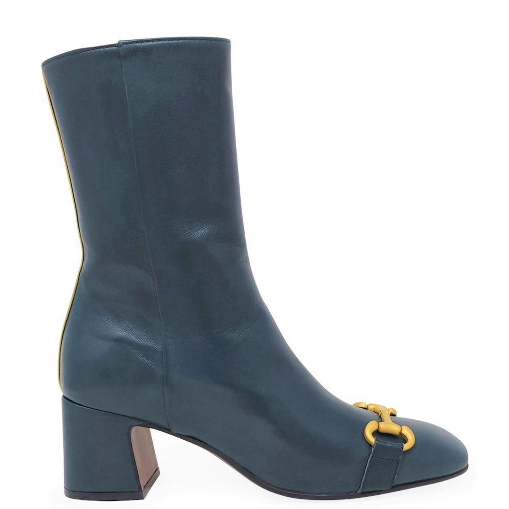 Blue ankle boot with gold buckle on a white background