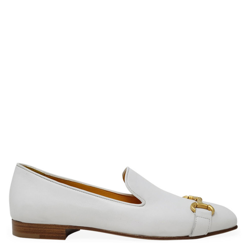 White loafer shoe with gold buckle on a white background