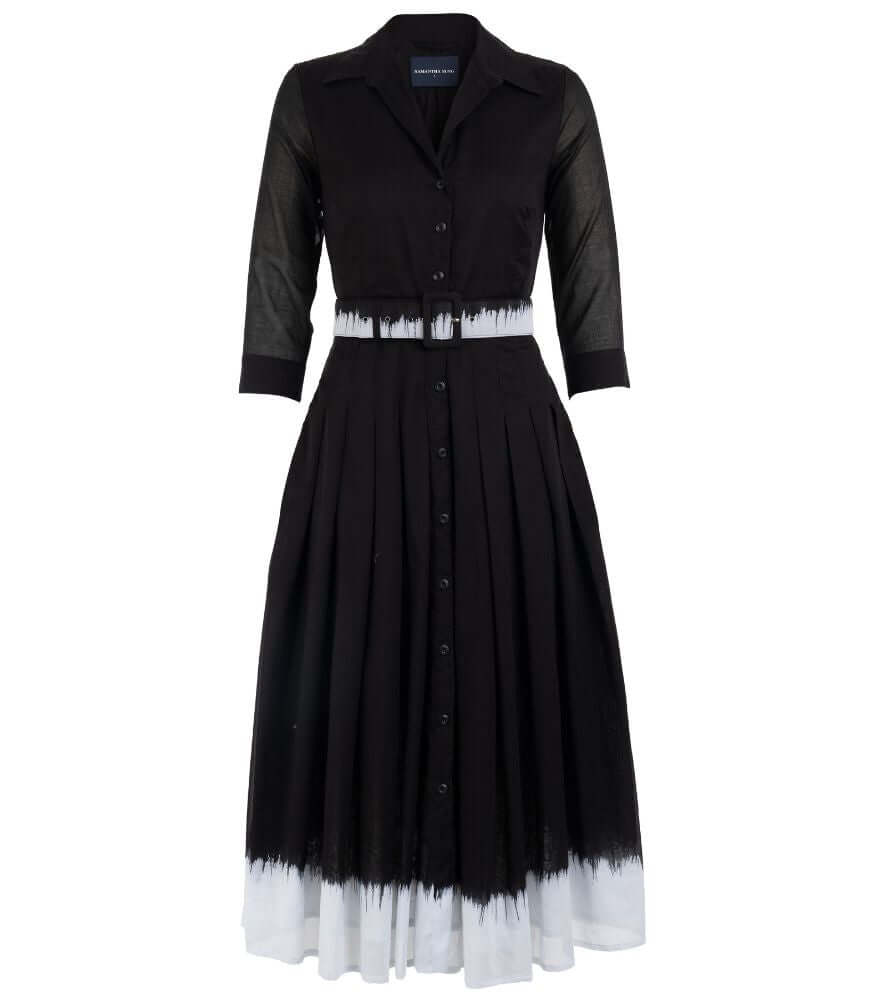 A knee-length dress with a collared neckline, three-quarter sleeves, and a flared skirt. Features a bold allover abstract pattern and fitted waist.