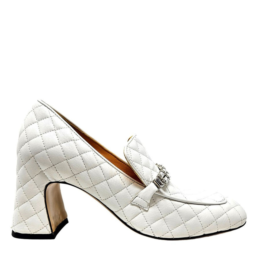 White quilted high-heeled shoe with a decorative clasp on a white background
