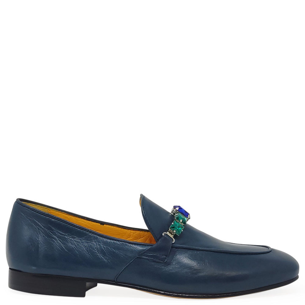 Blue leather loafer with decorative buckle on a white background