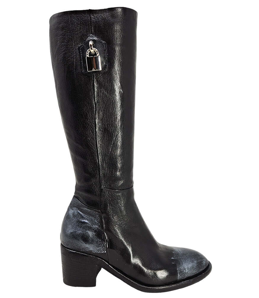 Tall leather boot featuring a softly rounded toe, mid-height stacked block heel, full side zipper for easy on and off, and a decorative metal lock accent near the top shaft. Crafted from premium leather with artisanal distressed detailing at the toe and h