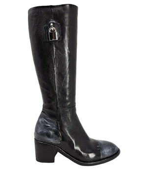 Tall leather boot featuring a softly rounded toe, mid-height stacked block heel, full side zipper for easy on and off, and a decorative metal lock accent near the top shaft. Crafted from premium leather with artisanal distressed detailing at the toe and h