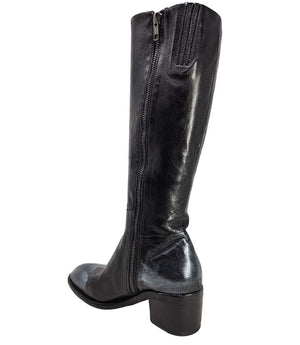 Tall leather boot featuring a softly rounded toe, mid-height stacked block heel, full side zipper for easy on and off, and a decorative metal lock accent near the top shaft. Crafted from premium leather with artisanal distressed detailing at the toe and h