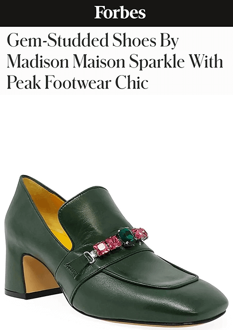 Screenshot of a Forbes article titled “Gem-Studded Shoes By Madison Maison Sparkle With Peak Footwear Chic,” featuring a close-up image of a green leather heeled loafer. The shoe has a chunky mid-heel and is adorned with a jeweled strap featuring green and pink gemstones. The interior is lined in a contrasting yellow leather.