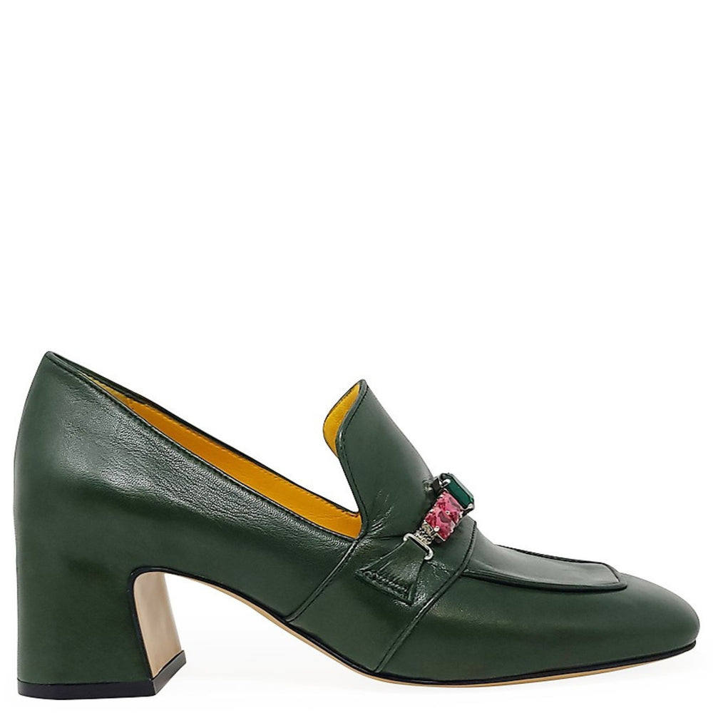Green leather shoe with a decorative brooch on a white background