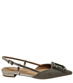 Pointed-toe slingback flat with low heel, adjustable ankle strap, and large decorative jewel embellishment on the toe. Features mixed material textures and an open heel design.