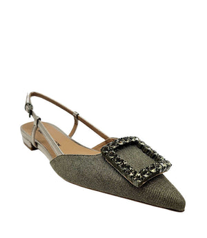 Pointed-toe slingback flat with low heel, adjustable ankle strap, and large decorative jewel embellishment on the toe. Features mixed material textures and an open heel design.