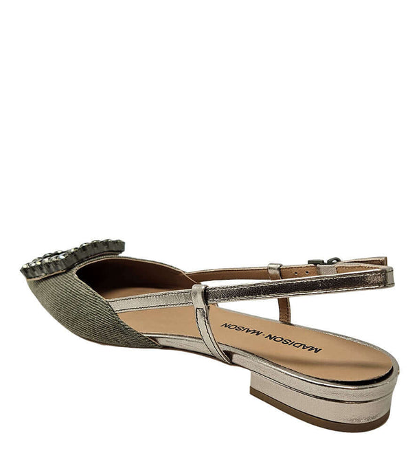 Pointed-toe slingback flat with low heel, adjustable ankle strap, and large decorative jewel embellishment on the toe. Features mixed material textures and an open heel design.