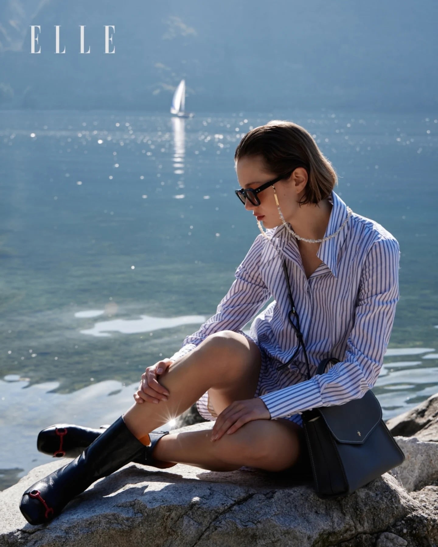 A mid-calf leather boot with a block heel and square toe, featuring a decorative metal accent across the toe. Designed by Madison in Beverly Hills and handcrafted in Italy.