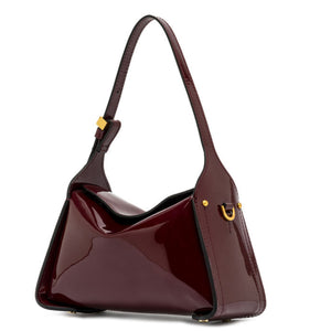 Shiny burgundy handbag with gold accents on a white background