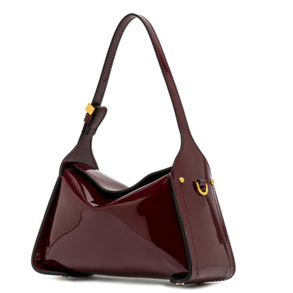 Shiny burgundy handbag with gold accents on a white background