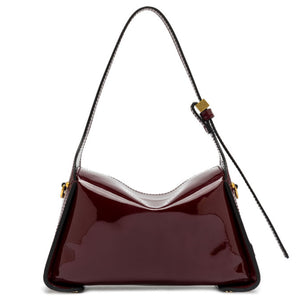 Shiny red handbag with a strap on a white background