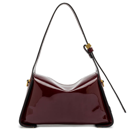 Shiny red handbag with a strap on a white background