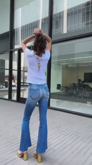 Flared-leg pants made in Italy with a mid-rise fit, featuring front and back pockets and star-shaped accents on the hip, lower leg, and back pocket. Displayed from multiple angles against a clean background