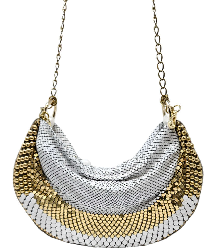 A metallic hobo-style handbag with a black and silver mesh design, accented by large silver beaded trim along the edges. The bag hangs from a silver chain strap and features a soft, slouchy silhouette. Designed by Madison in Beverly Hills