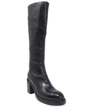"Knee-high leather boot with structured shaft, rounded toe, and stacked block heel. Designed with minimal stitching and a smooth finish