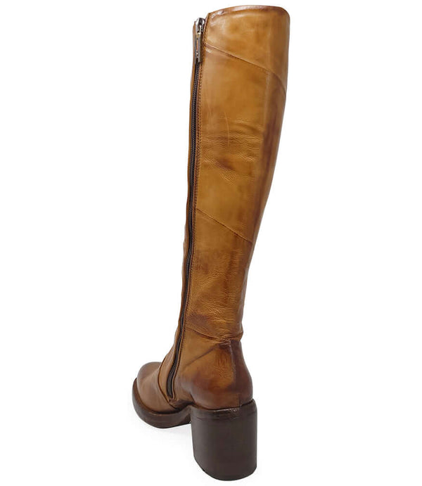 "Knee-high leather boot with structured shaft, rounded toe, and stacked block heel. Designed with minimal stitching and a smooth finish