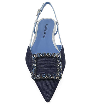 Pointed-toe slingback flat with low heel, adjustable ankle strap, and large decorative jewel embellishment on the toe. Features mixed material textures and an open heel design.