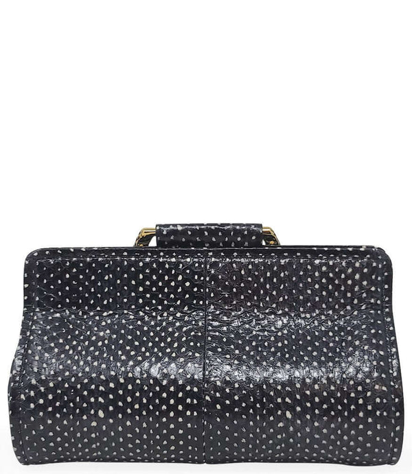 Structured mini handbag crafted from textured leather with a dotted pattern, featuring a sculptural metal snake-shaped top handle with dual serpent heads. Includes a detachable adjustable leather strap with metal clasps for versatile wear as a crossbody o