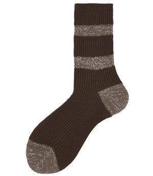 A mid-calf knit sock featuring a mix of textured panels, ribbed leg section, and bold horizontal stripes around the arch and cuff.