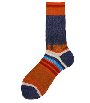 A mid-calf knit sock featuring a mix of textured panels, ribbed leg section, and bold horizontal stripes around the arch and cuff.
