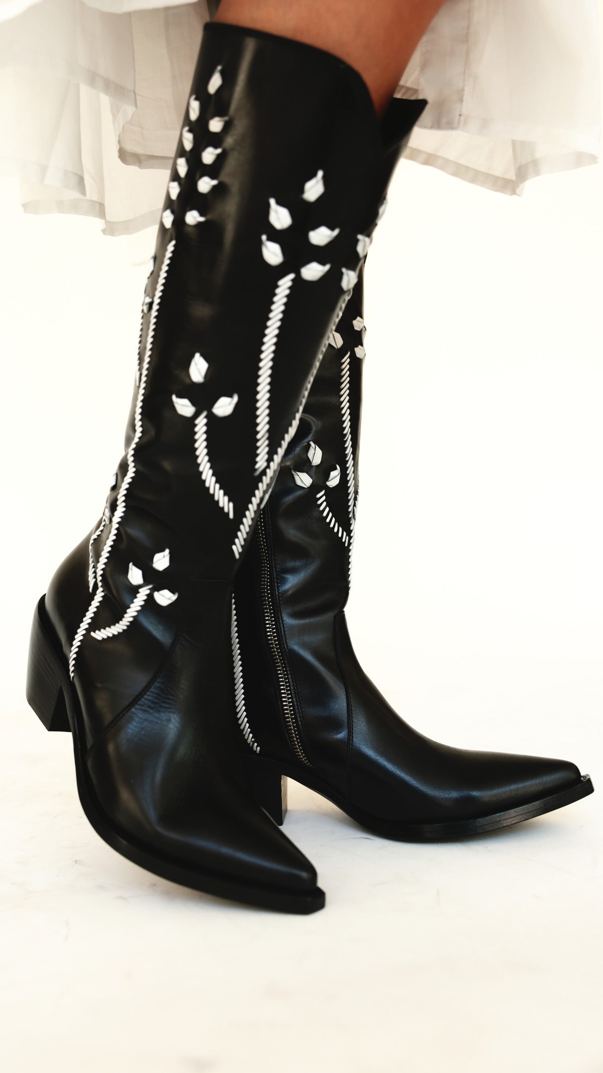 Madison Maison tall boot with white floral embroidery, graded still from the campaign film