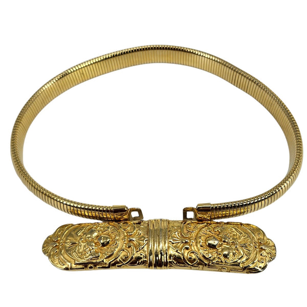 Gold bracelet with intricate designs on a white background