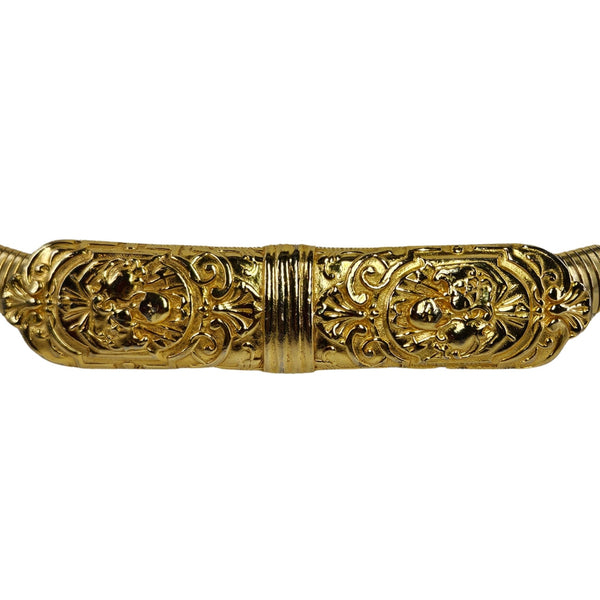 Decorative gold object with intricate patterns on a white background
