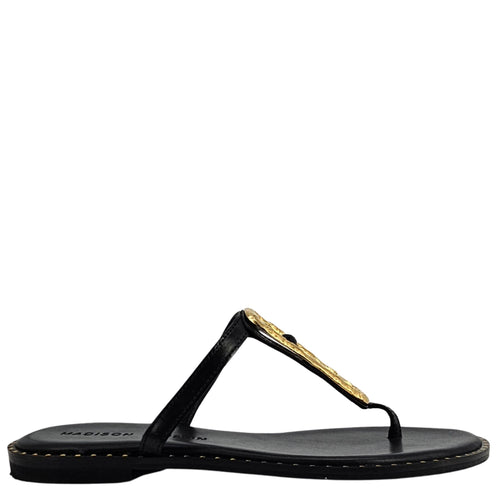 Black sandal with gold embellishment on a white background