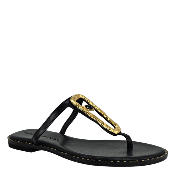 Black sandal with a gold buckle on a white background