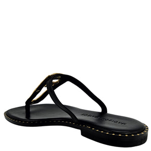 Black sandal with gold accents on a white background