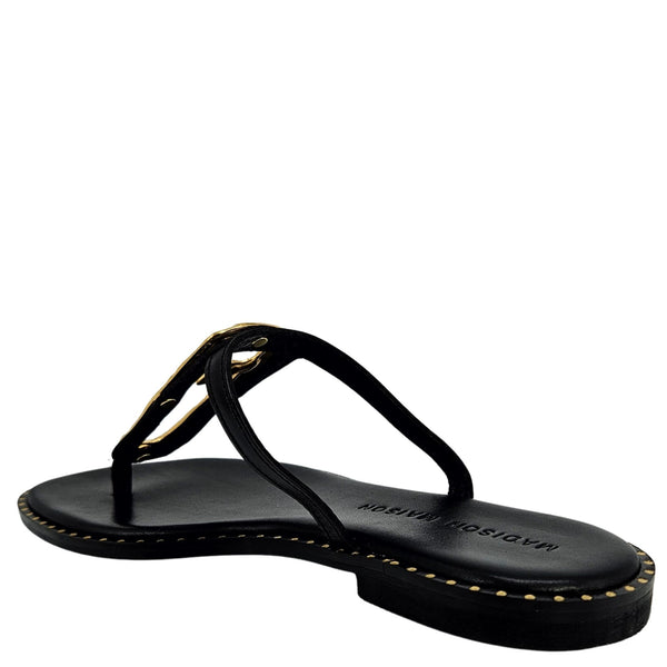 Black sandal with gold accents on a white background