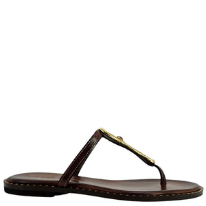 Brown sandal with a gold accent on a white background
