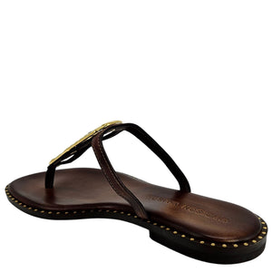 Brown sandal with gold accents on a white background