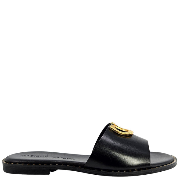 Black sandal with gold buckle on a white background