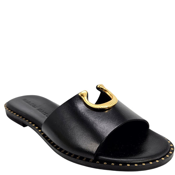 Black sandal with gold accents on a white background