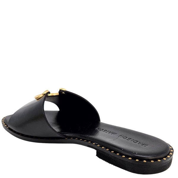 Black sandal with gold accents on a white background
