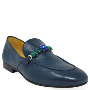 Blue loafer with gemstone embellishments on a white background